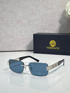 Blue-tone sunglasses with gold bar detail and geometric logo temples