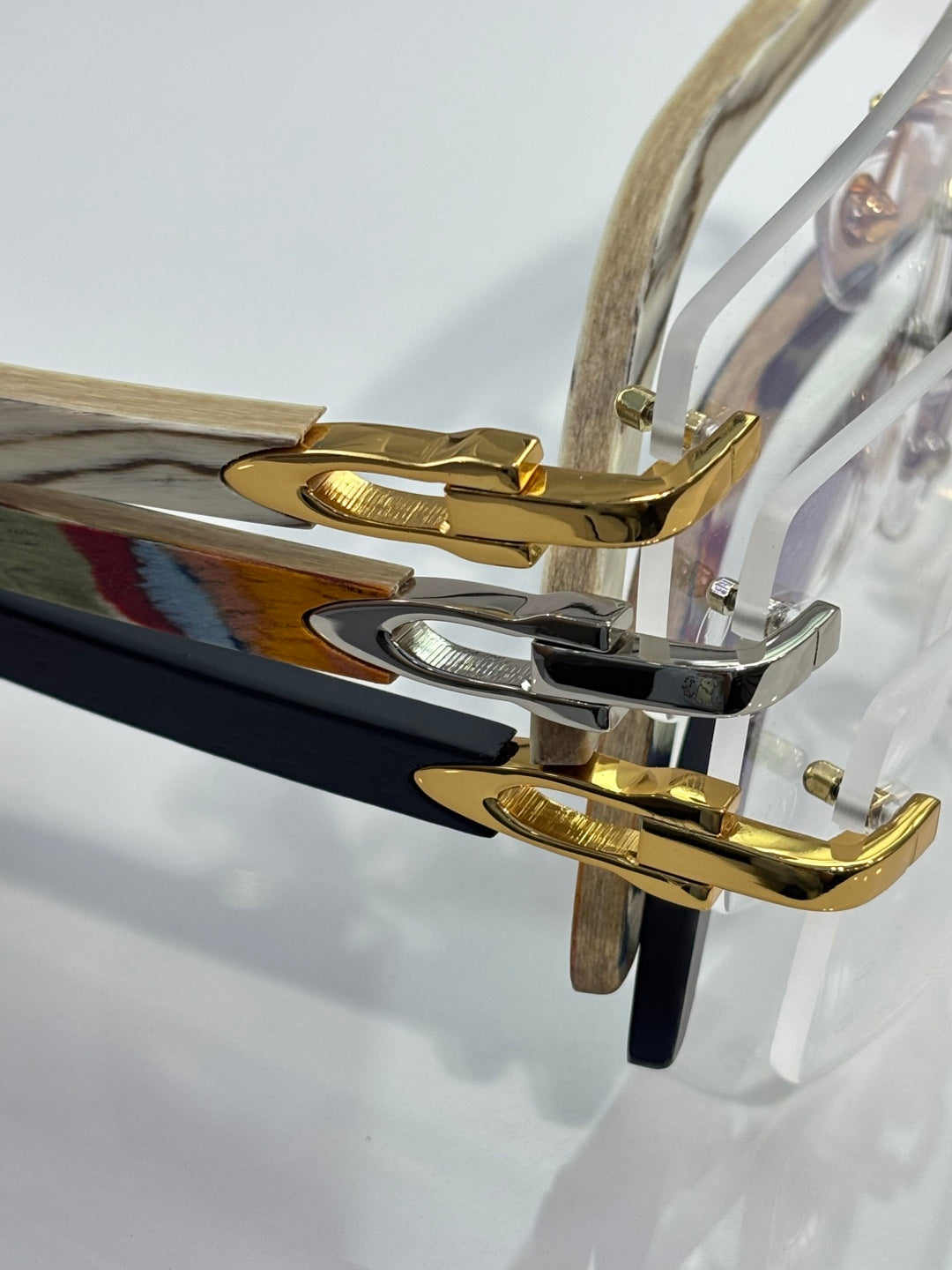 Cartier glasses close-up: blue and gold temple with silver hinge hardware