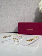Cartier glasses with clear lenses, gold frame, and light tortoise temple accents