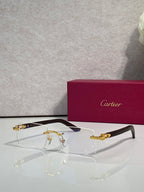 Cartier glasses with clear lenses and gold metal frame, dark blue temple tips