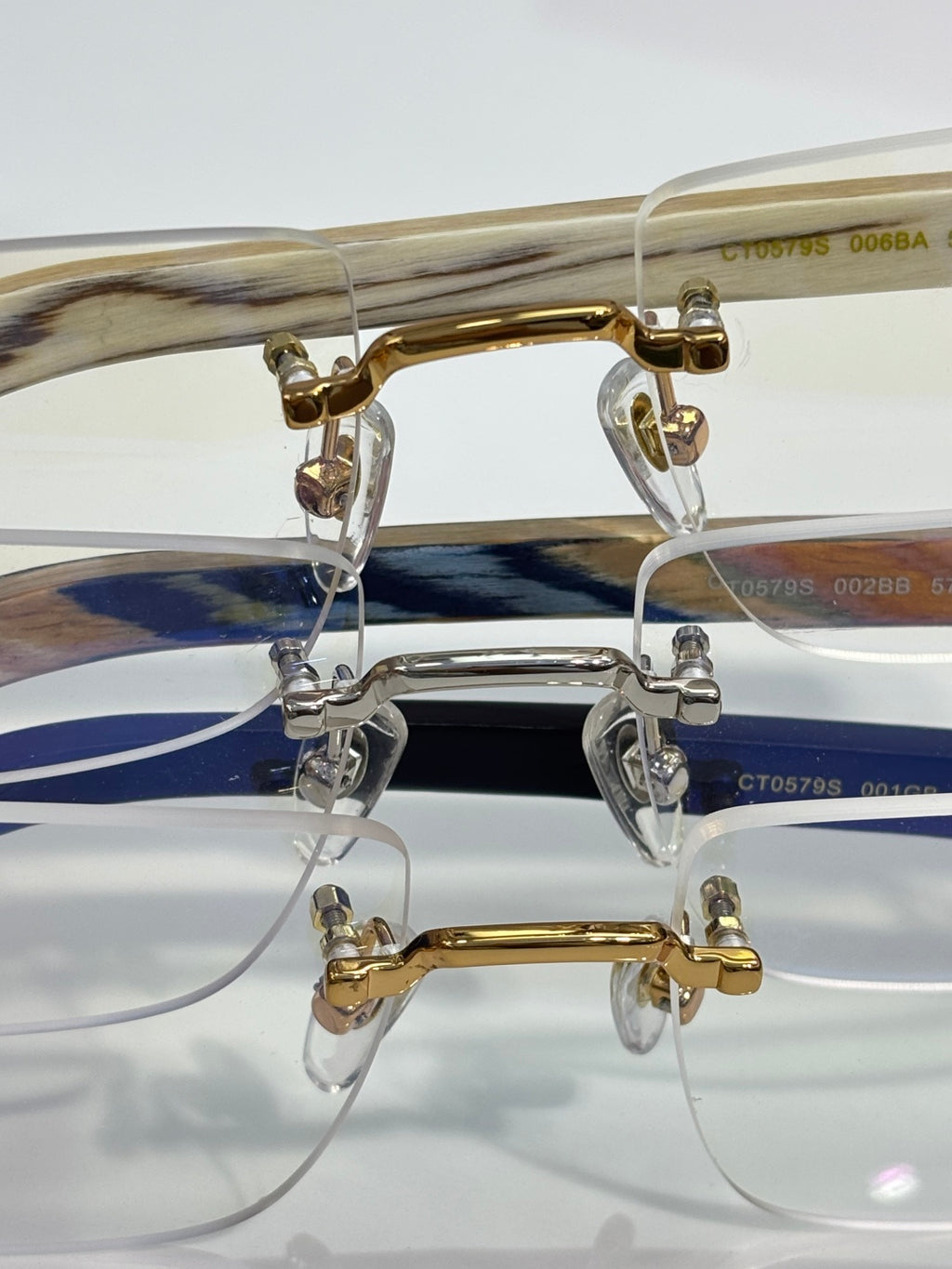 Cartier glasses close-up: gold and silver metal frames with clear lenses