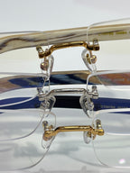 Cartier glasses close-up: gold and silver metal frames with clear lenses