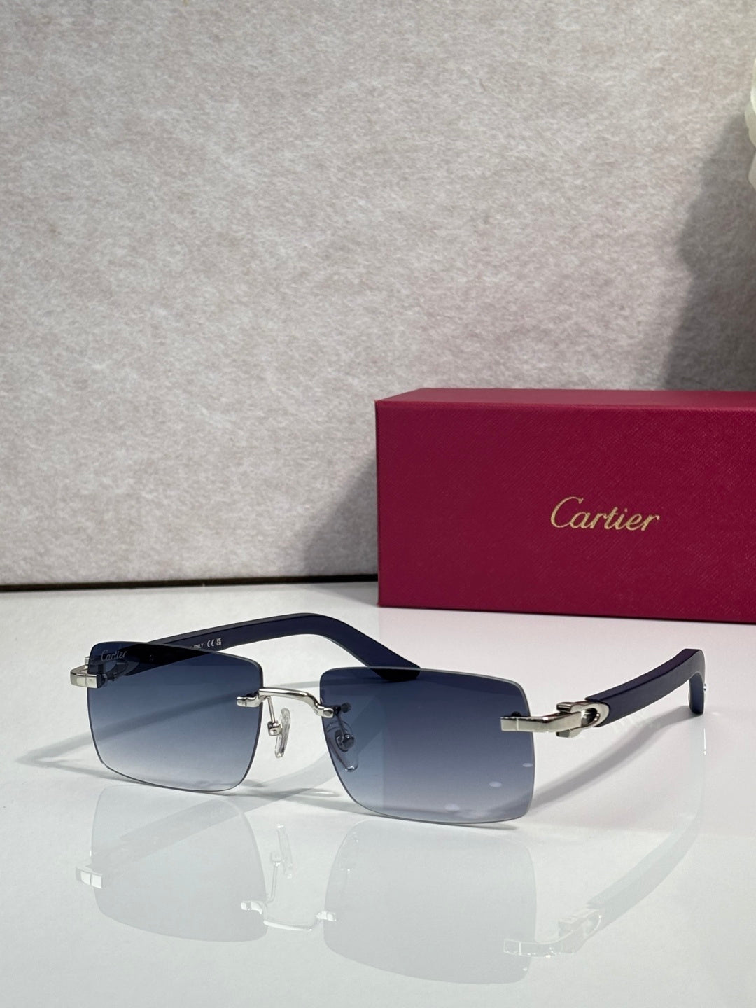 Sunglasses with blue tinted lenses, gold metal frame and dark arms
