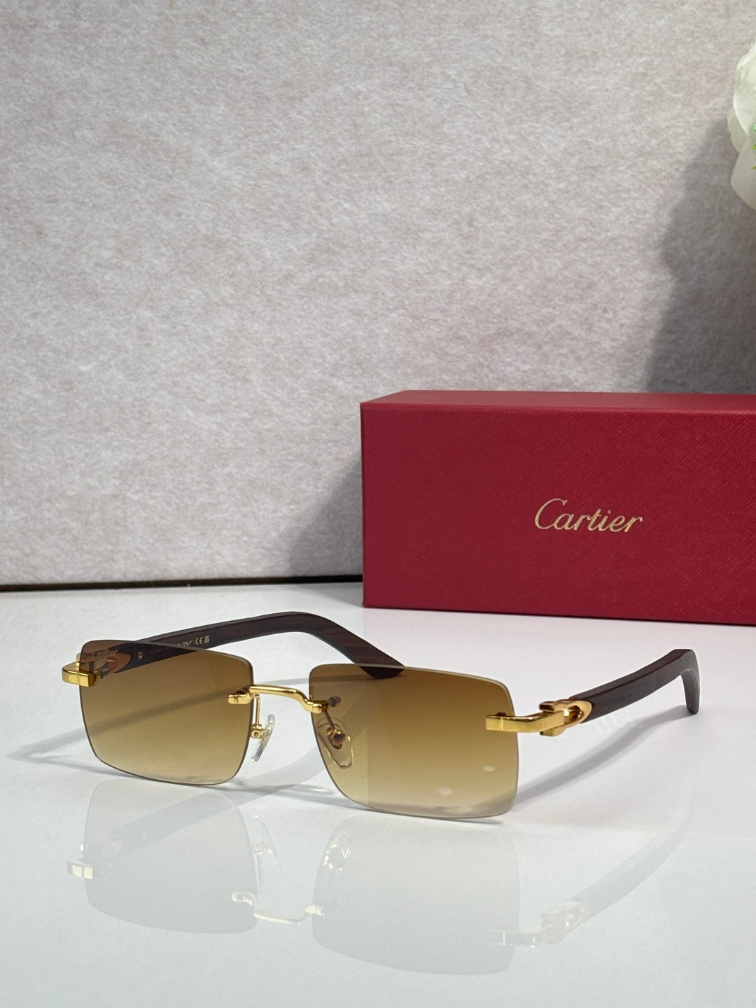 Sunglasses with yellow tinted lenses, gold frame and dark arms