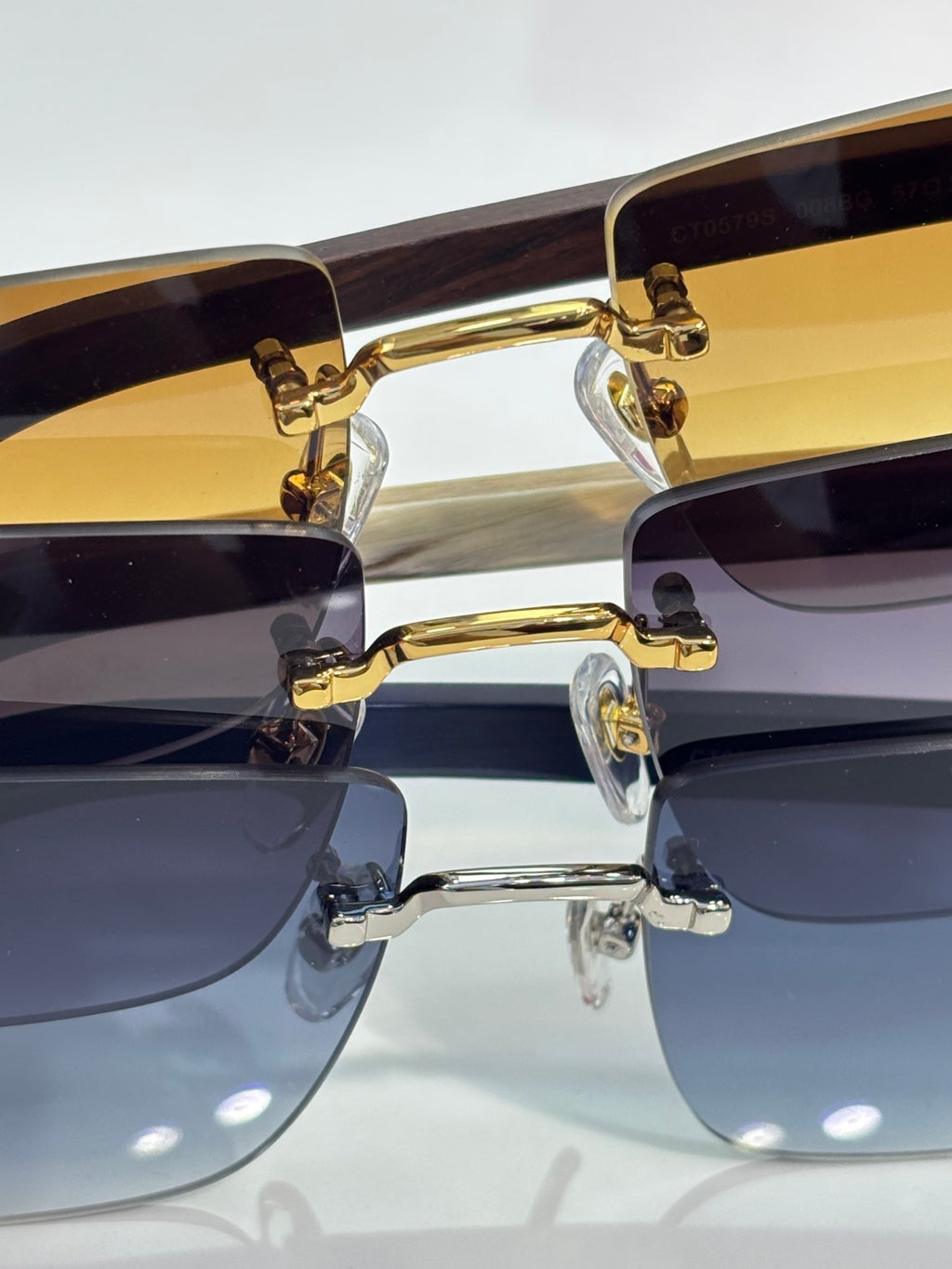 Gold sunglasses with gradient dark lenses and visible hinge hardware