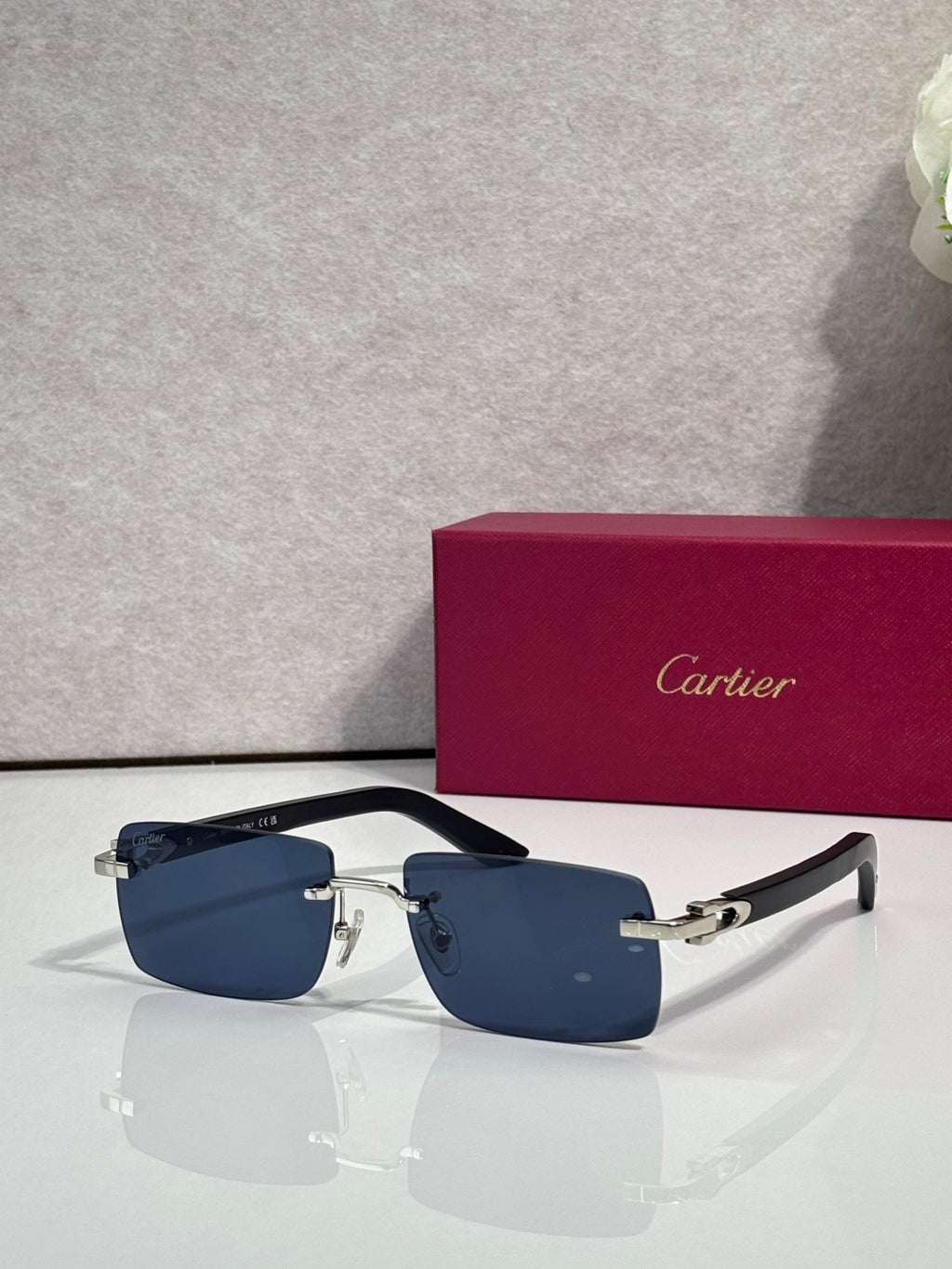 Sunglasses with blue tinted lenses, gold metal frame and dark arms