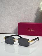 Sunglasses with gray tinted lenses, gold metal frame and dark arms