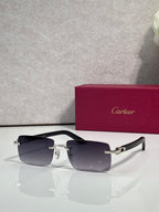 Sunglasses with dark tinted lenses, gold metal frame and black arms