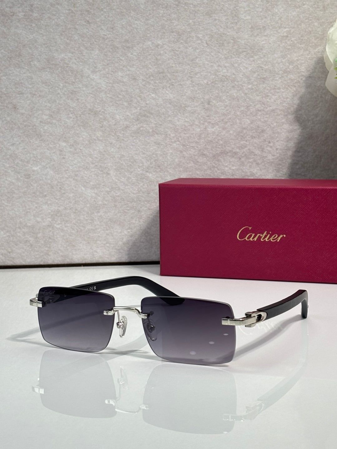 Sunglasses with dark tinted lenses, gold metal frame and black arms