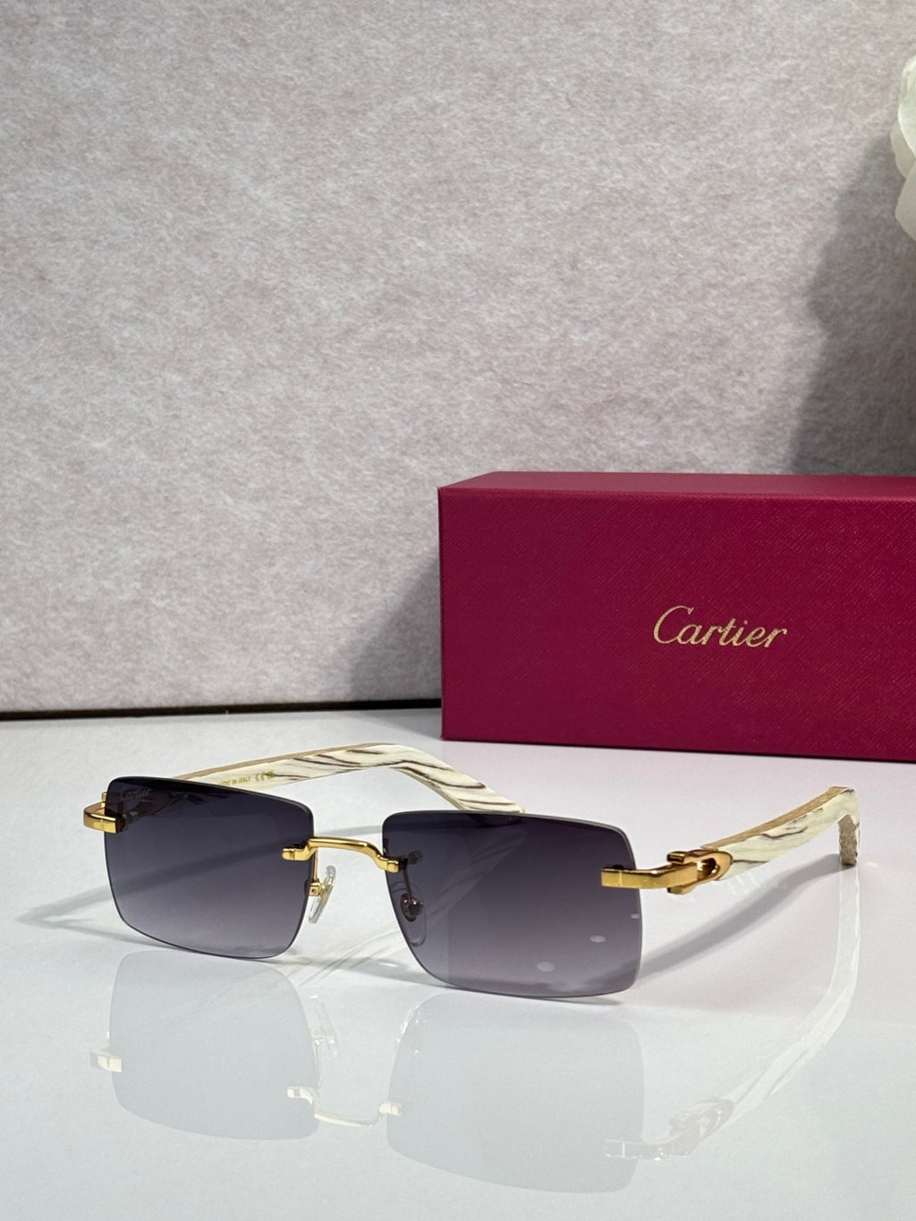 Sunglasses with amber tinted lenses, gold frame and light arms
