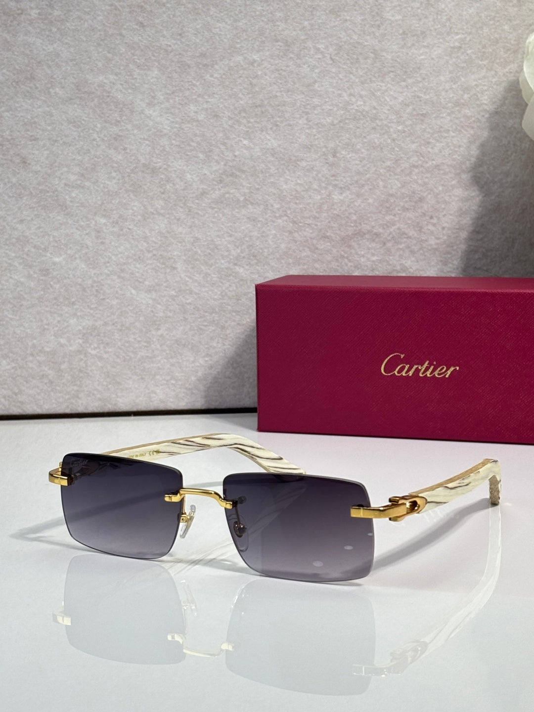 Sunglasses with amber tinted lenses, gold frame and light arms