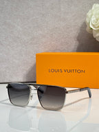 Louis Vuitton sunglasses with dark tinted lenses and gold-tone bridge detail