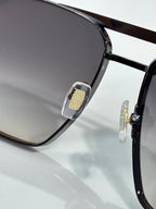 Louis Vuitton sunglasses close-up of frame hinge and gold-tone emblem