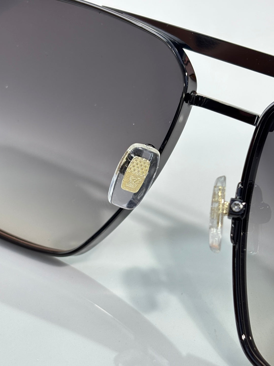 Louis Vuitton sunglasses close-up of frame hinge and gold-tone emblem