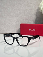Prada black full-rim eyeglasses with clear lenses and PRADA logo temple details