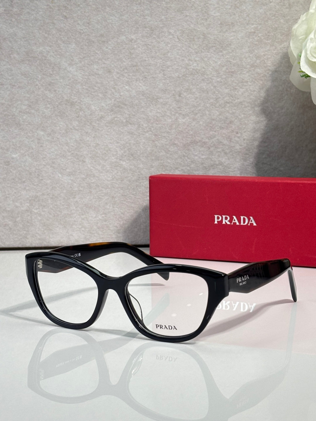 Prada black full-rim eyeglasses with clear lenses and PRADA logo temple details
