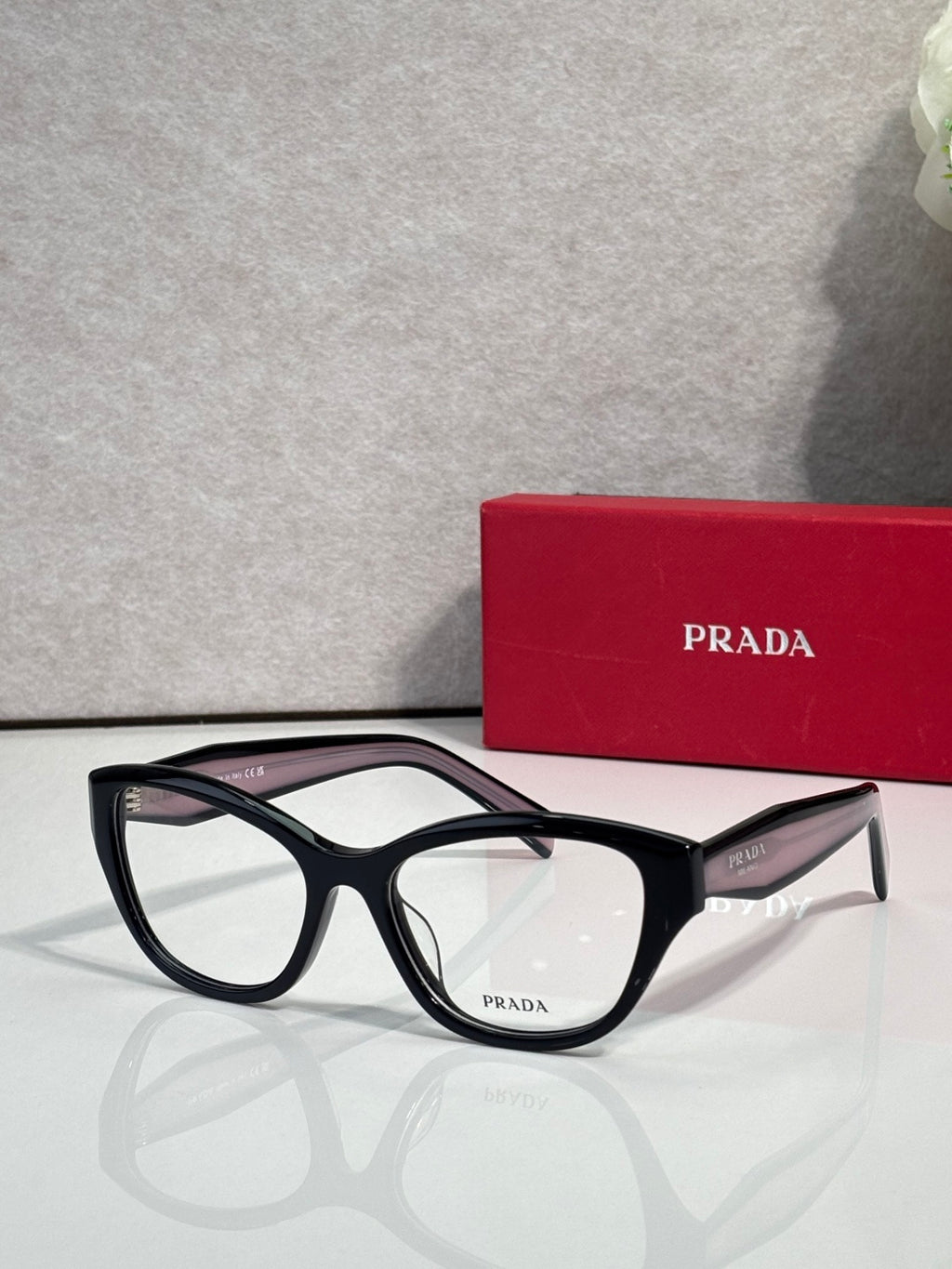 Prada black full-rim eyeglasses with clear lenses and angular acetate frame