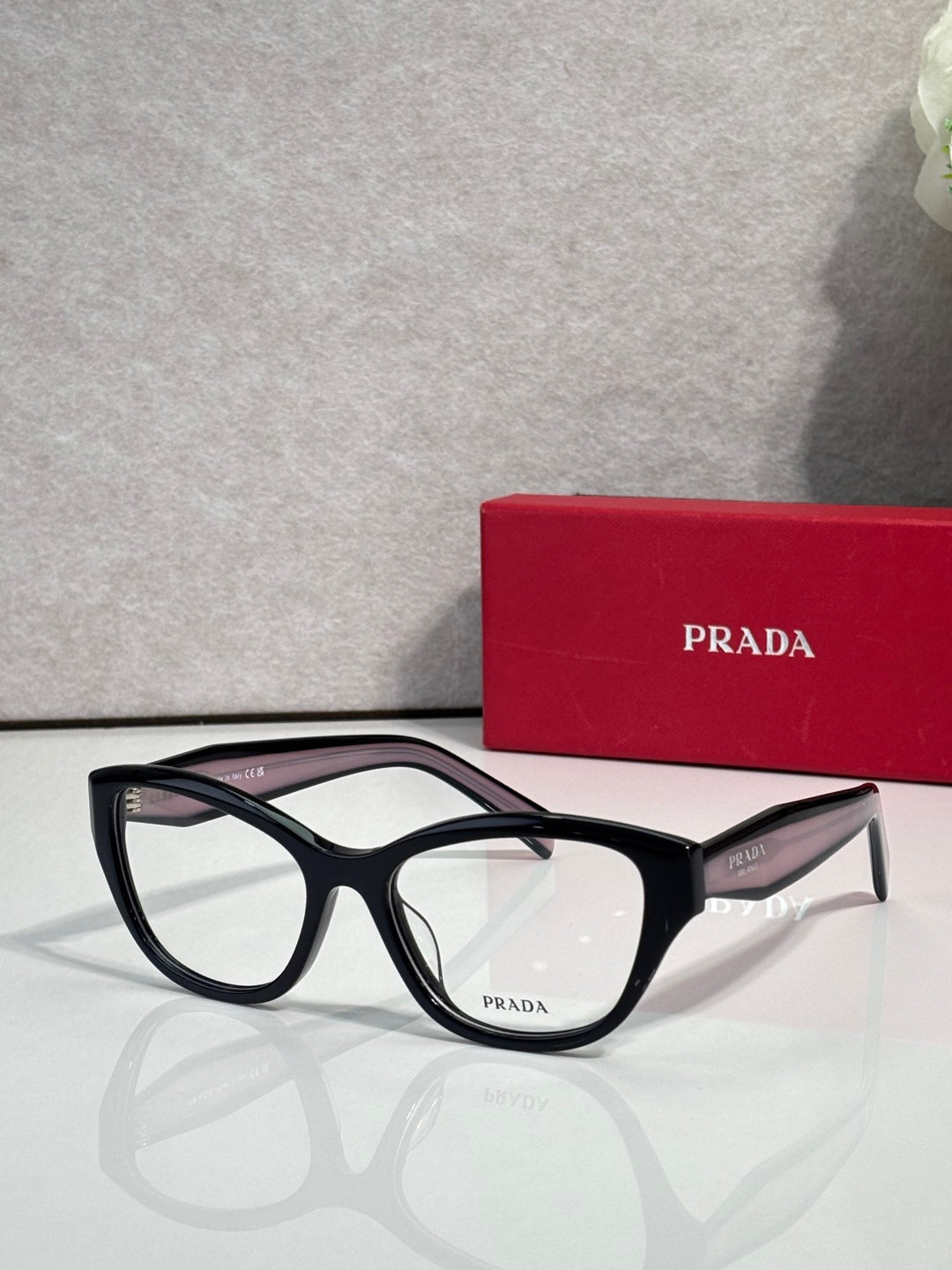 Prada black full-rim eyeglasses with clear lenses and angular acetate frame