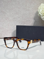 Tortoiseshell eyeglass frame with clear lenses and DIOR logo on temple