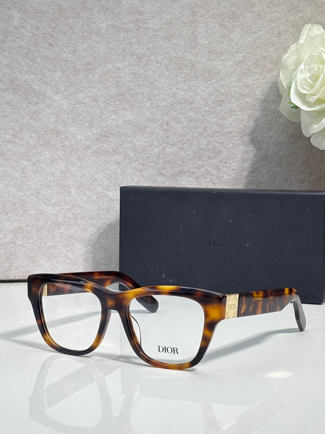 Tortoiseshell eyeglass frame with clear lenses and DIOR logo on temple