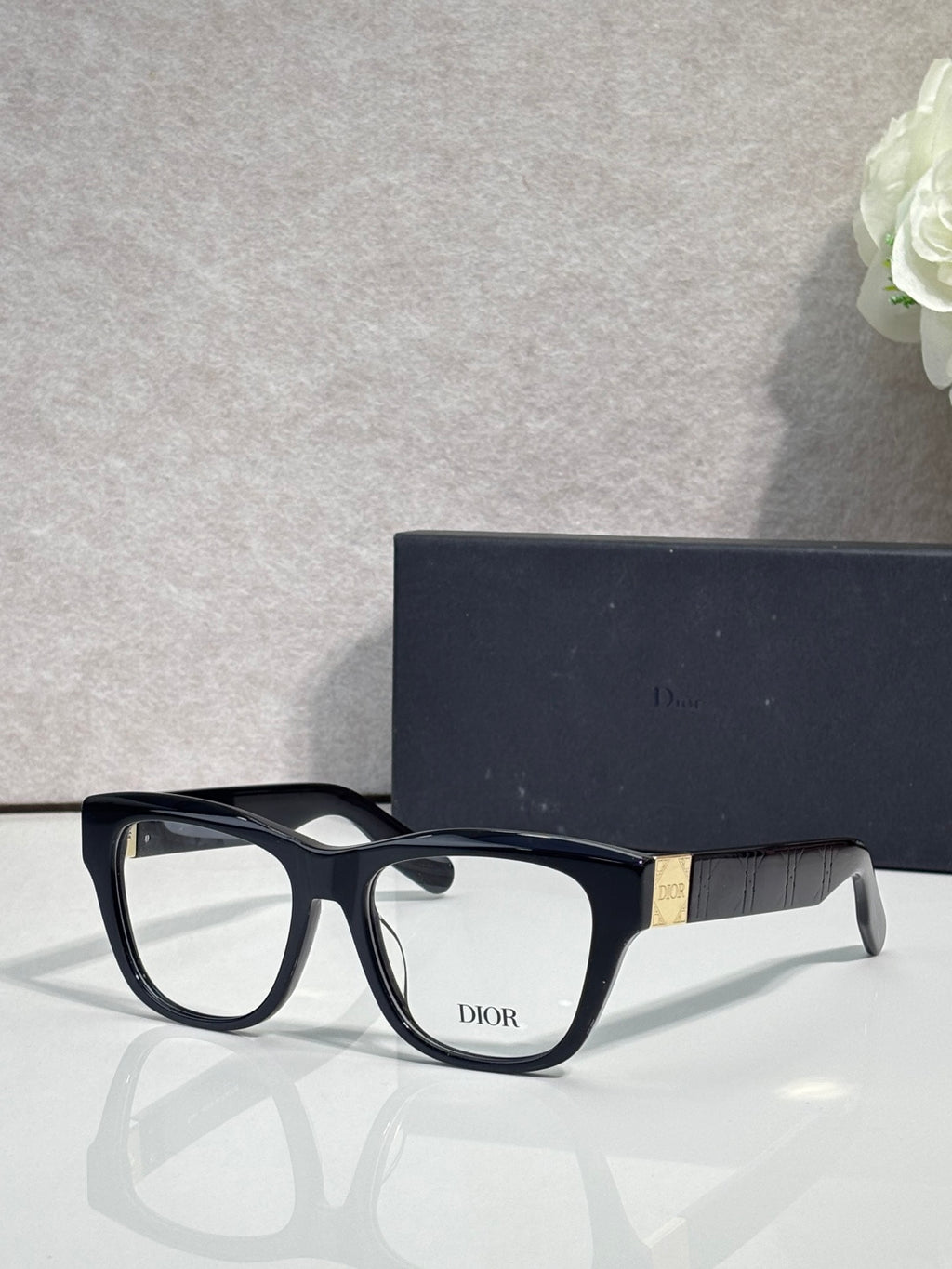 Black eyeglass frame with clear lenses and DIOR logo on front