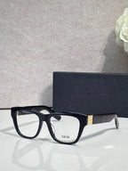 Black eyeglass frame with clear lenses and DIOR logo on front