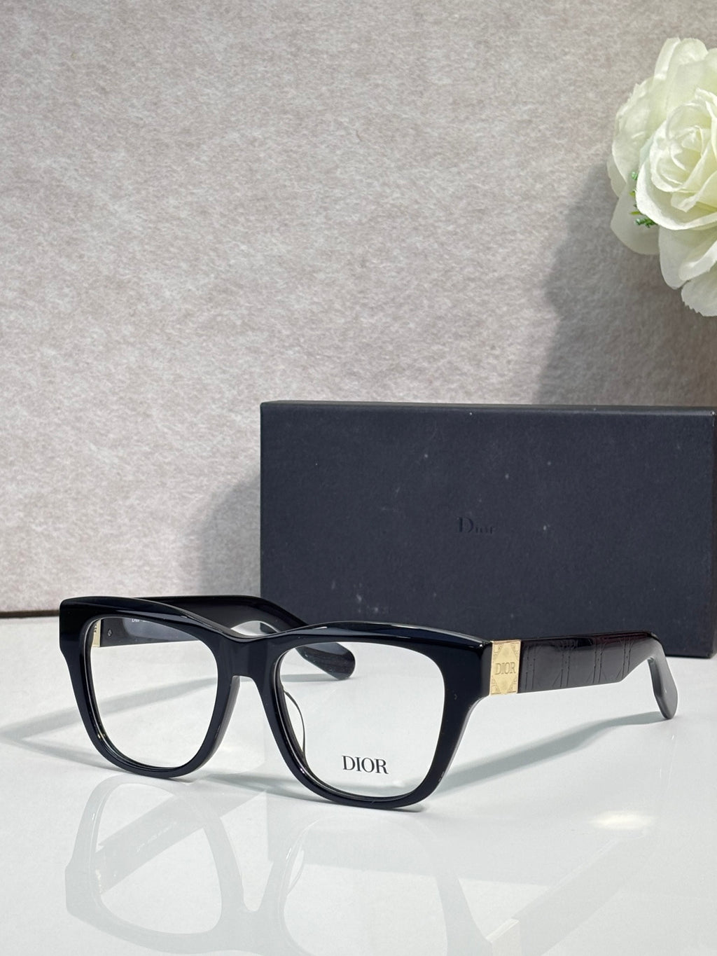 Black eyeglass frame with clear lenses and DIOR logo on front
