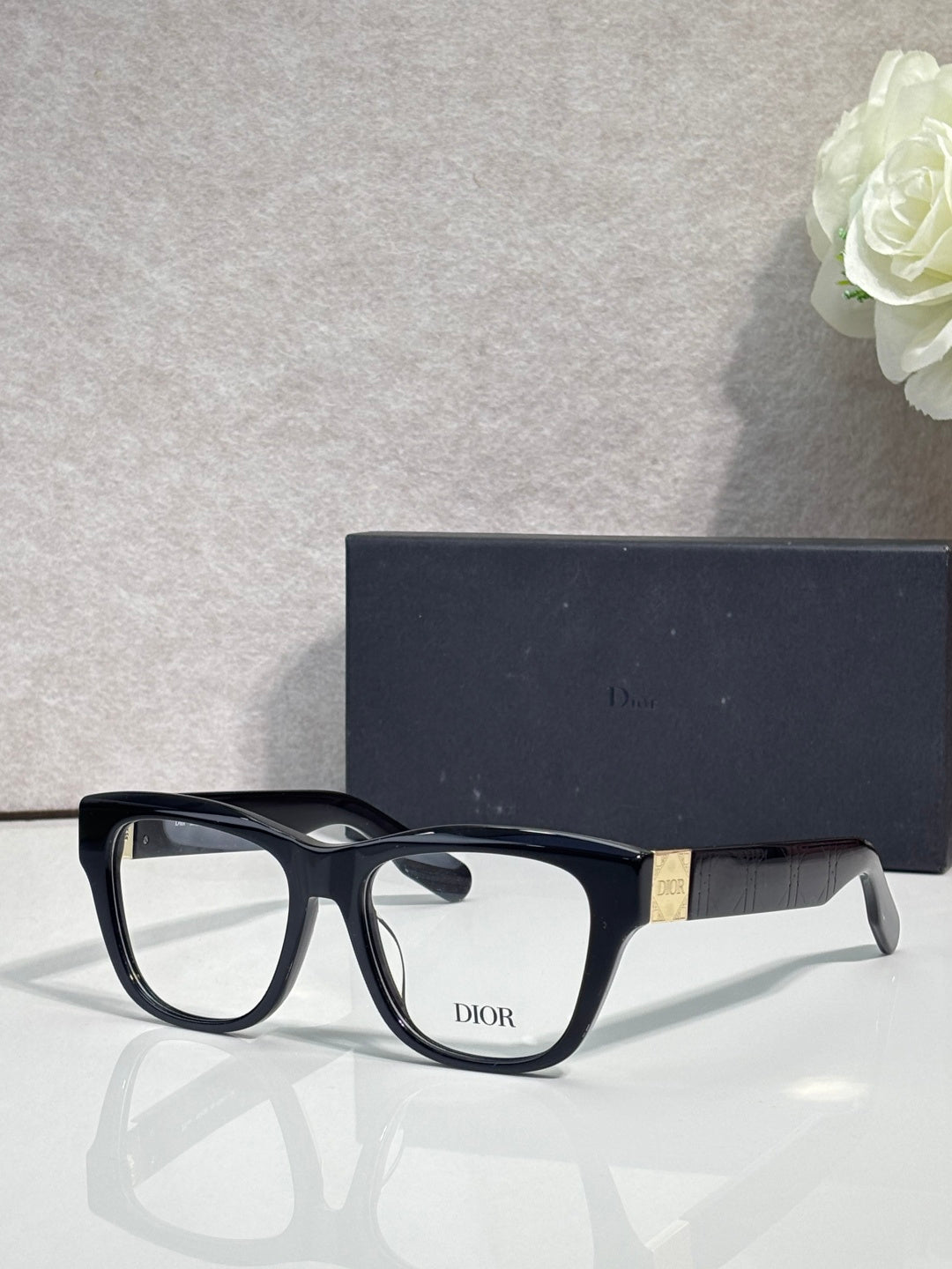 Black eyeglass frame with clear lenses and DIOR logo on front
