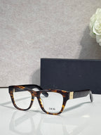 Tortoiseshell eyeglass frame with clear lenses and DIOR logo on front