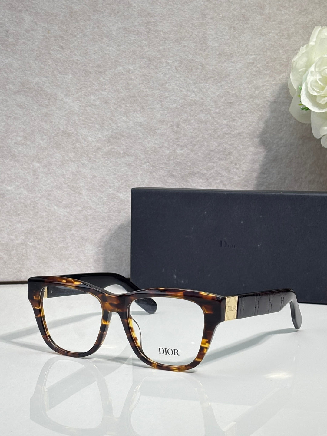 Tortoiseshell eyeglass frame with clear lenses and DIOR logo on front
