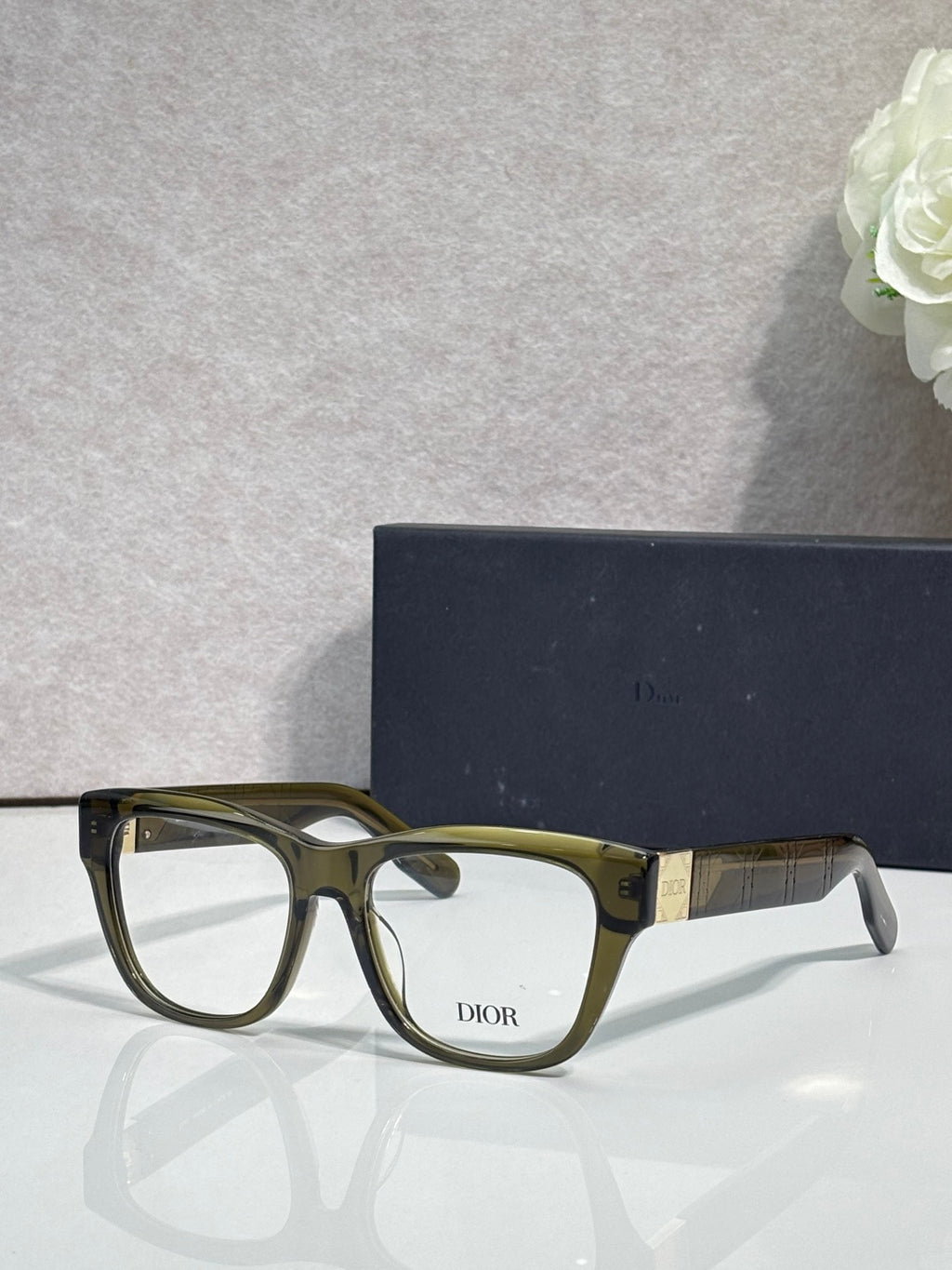 Olive eyeglass frame with clear lenses and DIOR logo on front
