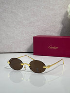 Cartier round sunglasses with gold frame and dark brown lenses