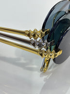 Cartier sunglasses close-up of gold spiked hinge and dark tinted lens