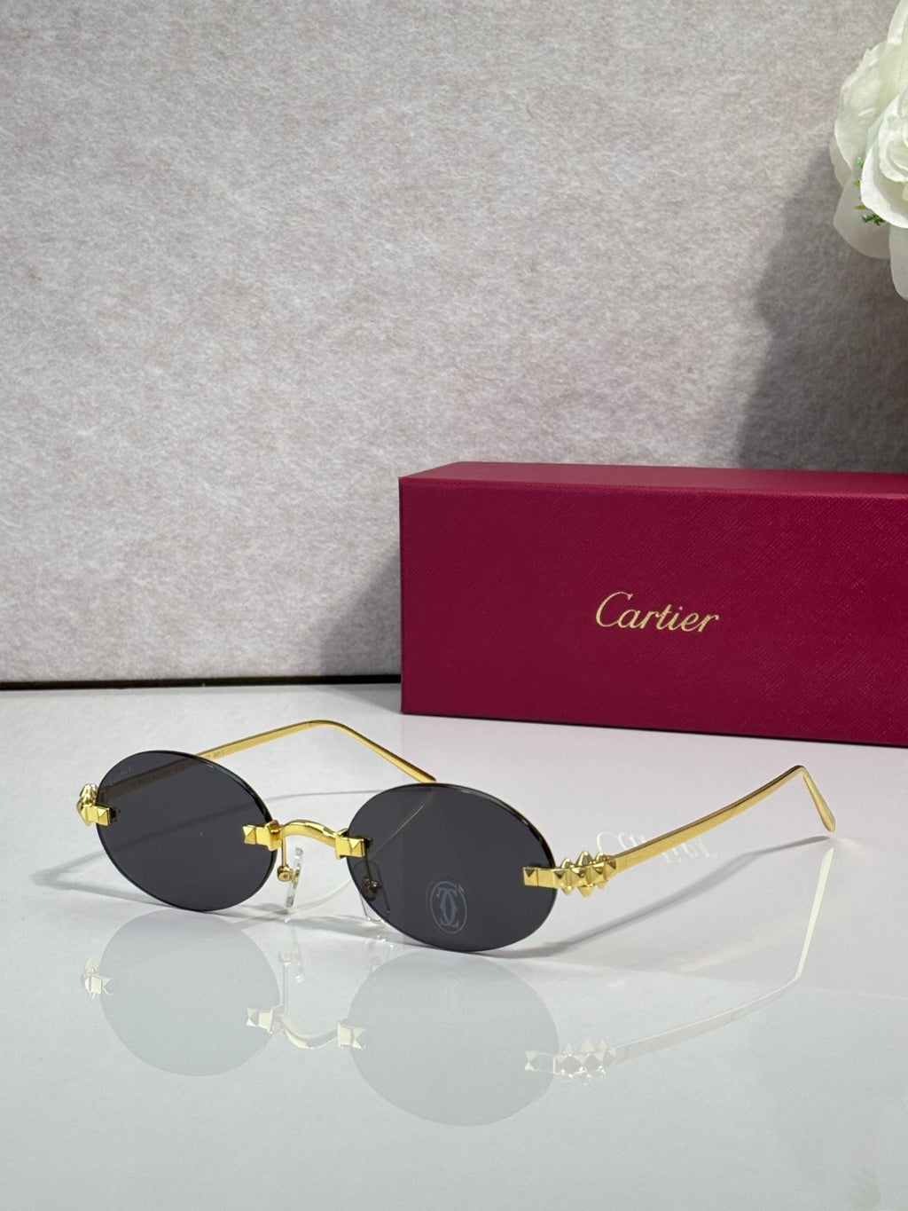 Cartier round sunglasses with black frame and dark tinted lenses