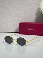 Cartier round sunglasses with black frame and dark tinted lenses
