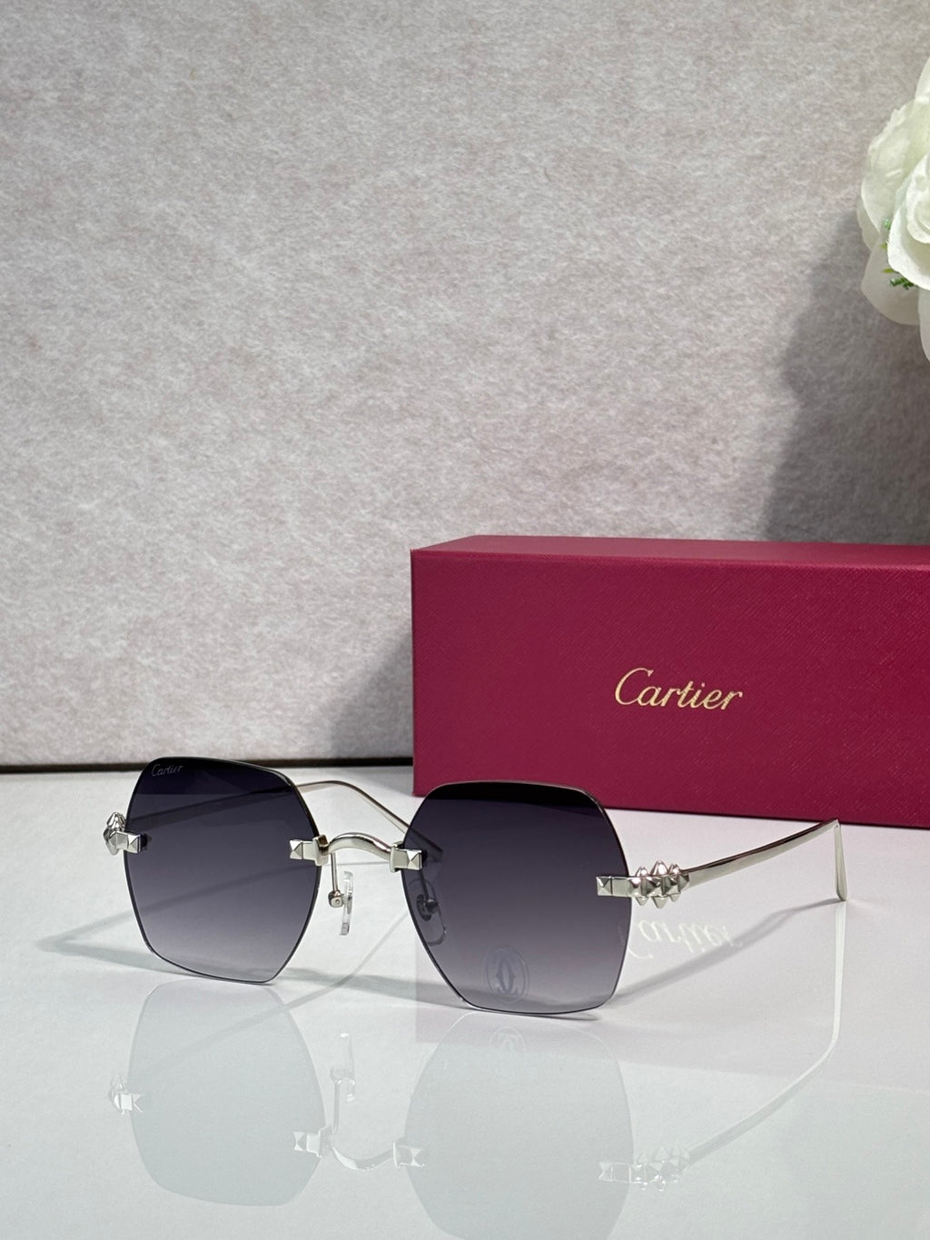 Silver metal-frame glasses with black tinted lenses and jeweled connector hardware