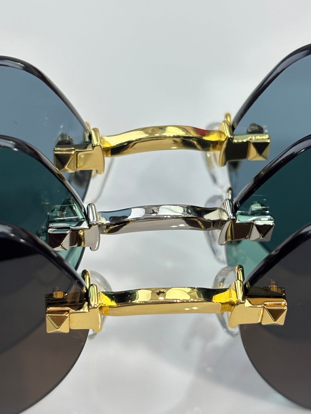 Two-tone gold-and-silver metal glasses hinge with stacked geometric studs