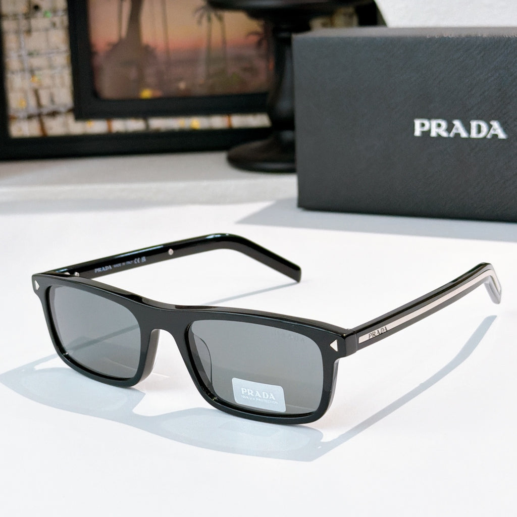 Prada sunglasses with black frame, dark lenses, and gold-accent metal temples