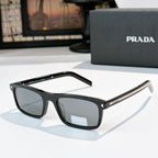 Prada sunglasses with black frame, dark lenses, and gold-accent metal temples
