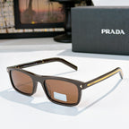 Prada sunglasses with black frame and brown tinted lenses, gold-accent metal temples