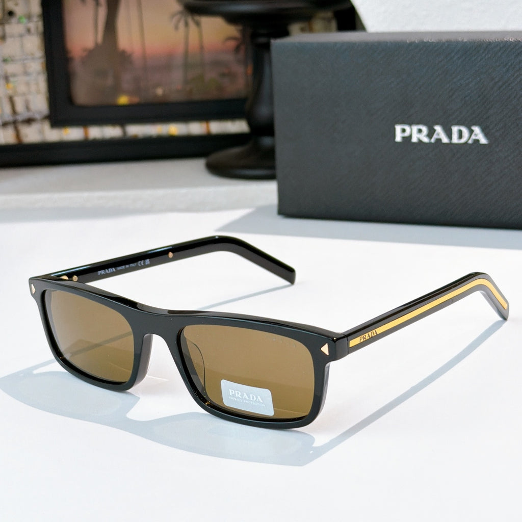 Prada sunglasses with black frame and amber-brown tinted lenses, metal temples with logo