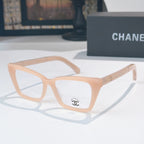 Light beige square eyeglasses with clear lenses and emblem on temple