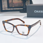 Tortoiseshell square eyeglasses with clear lenses and emblem at temple