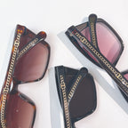 Assorted Chanel sunglasses with dark, tortoiseshell frames and chain-detail temples