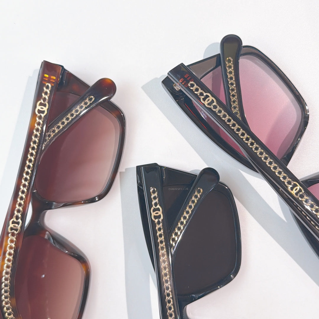 Assorted Chanel sunglasses with dark, tortoiseshell frames and chain-detail temples