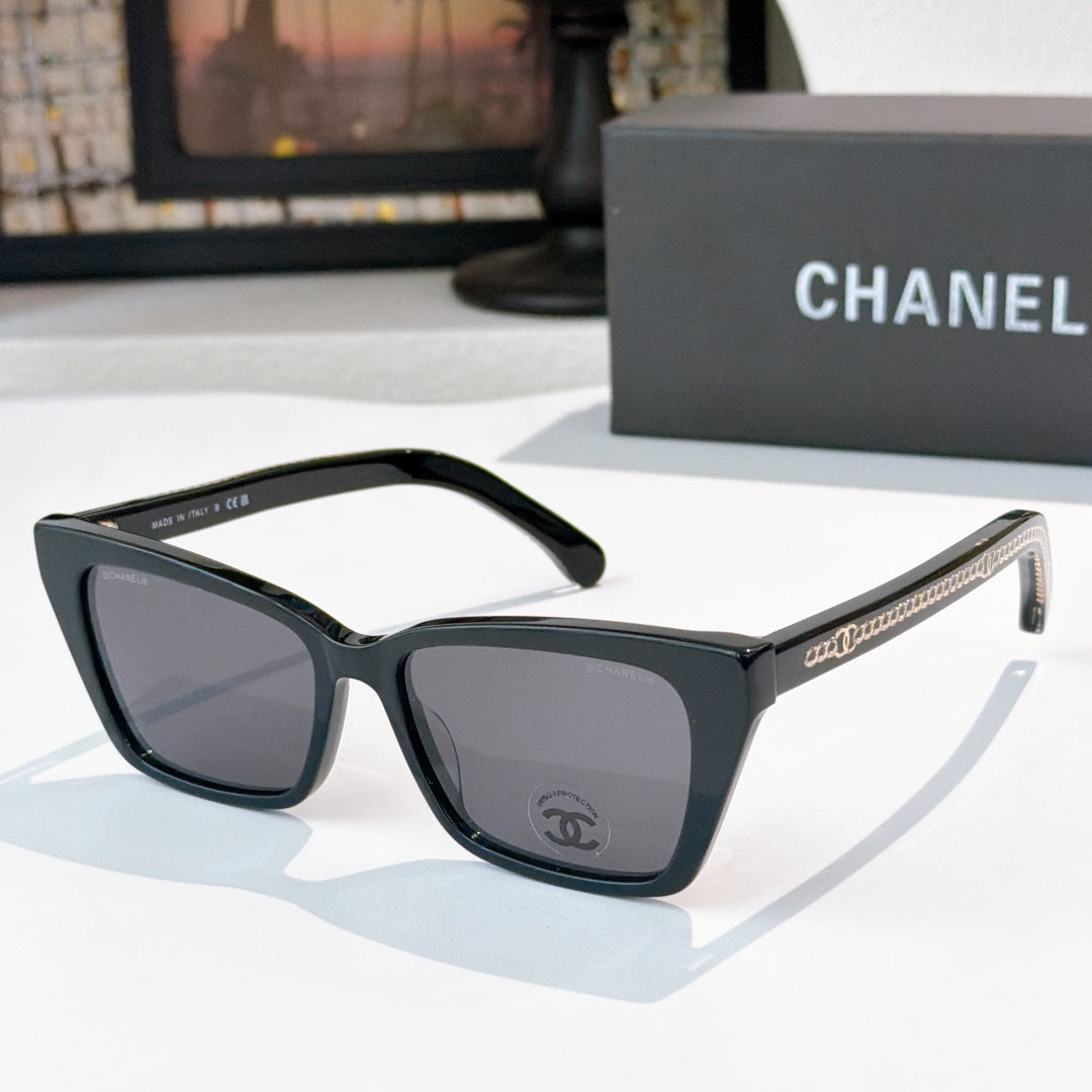 Chanel sunglasses with black frames and smoky dark tinted lenses