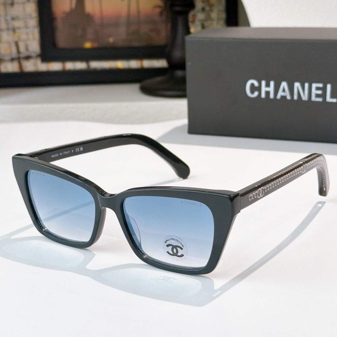 Chanel sunglasses with black frames and blue tinted lenses