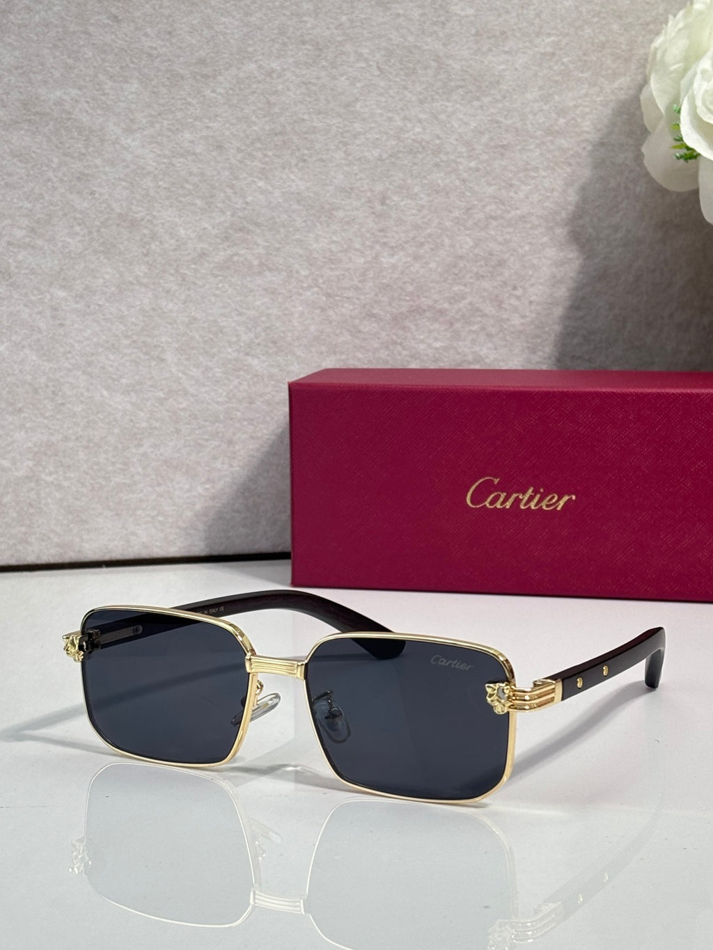 Cartier sunglasses with gold-tone frame and dark lenses, rounded square silhouette
