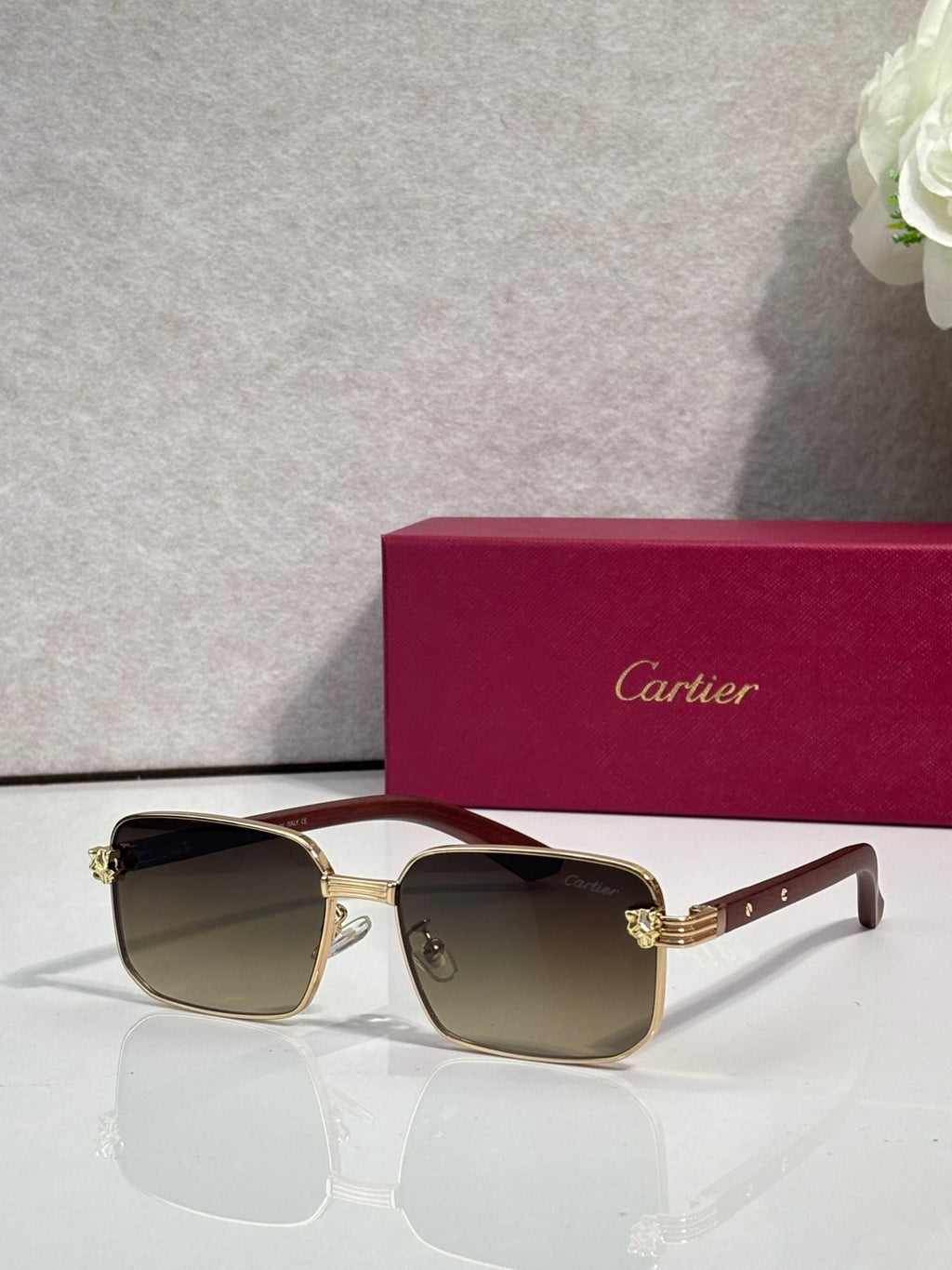 Cartier sunglasses with gold-tone frame and gradient lenses, shield-style cat-eye shape