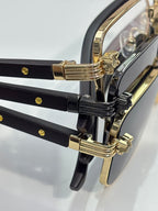 Cartier glasses close-up of black temples with gold metal hinge details